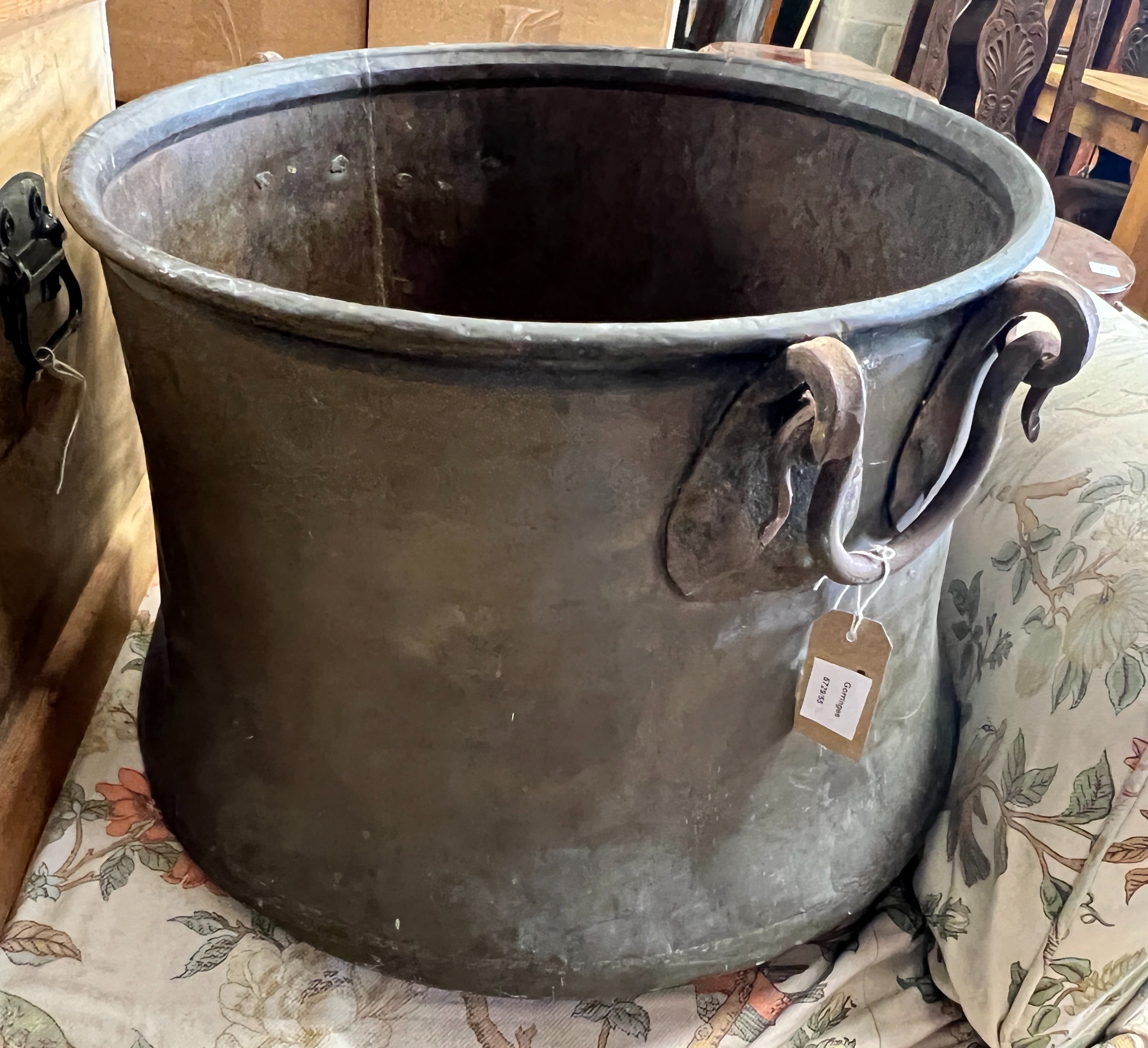 A Victorian circular copper cauldron with wrought iron handles, diameter 56cm, height 42cm